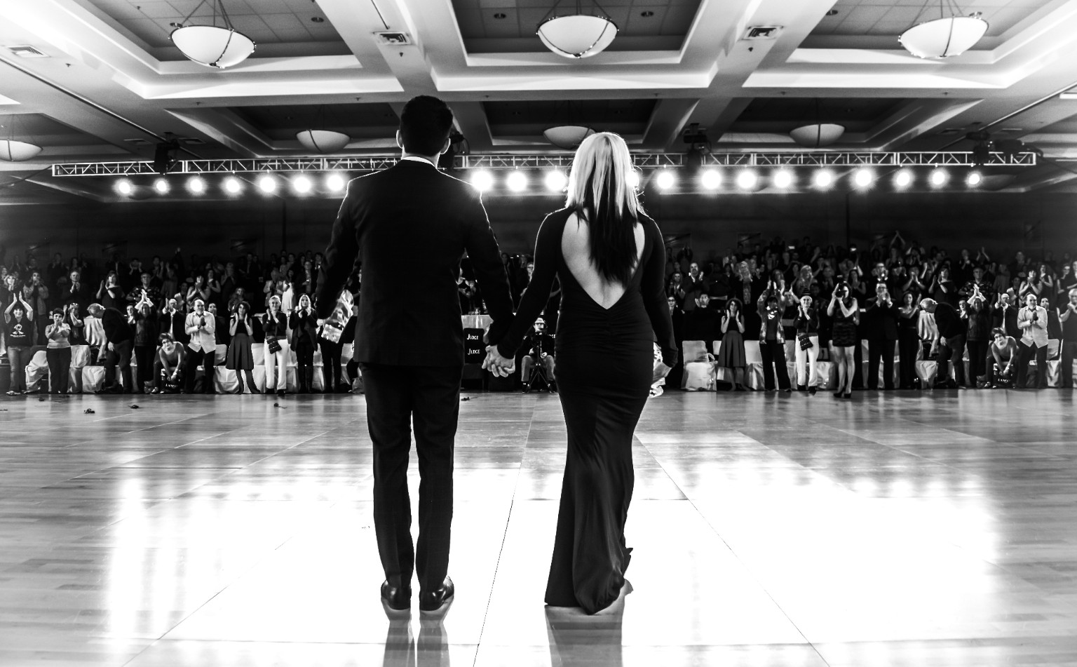 Jordan and Tatiana holding hands as the audience applauds