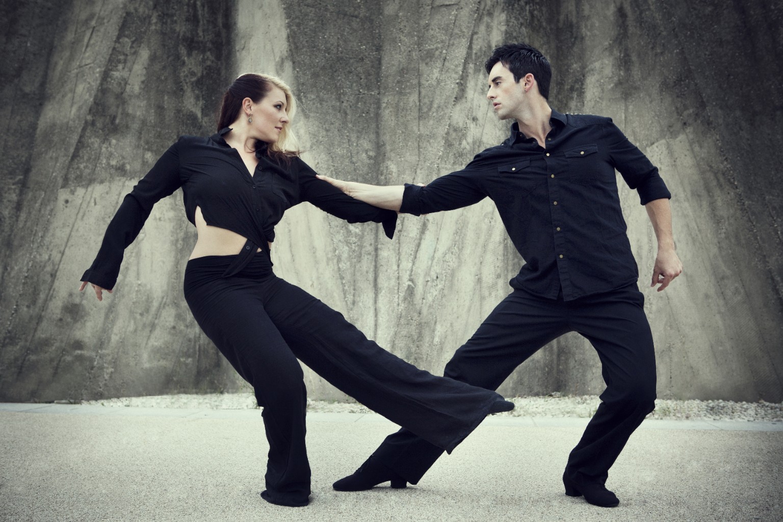 Jordan and Tatiana extending into a connected West Coast Swing pose